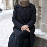 Brimley Knit Snood in beige worn with a charcoal wool coat, front view