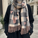 Halloway check blanket scarf worn over a coat, front view