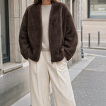 Norwood Teddy Fleece Jacket in chocolate brown worn with cream trousers, front view